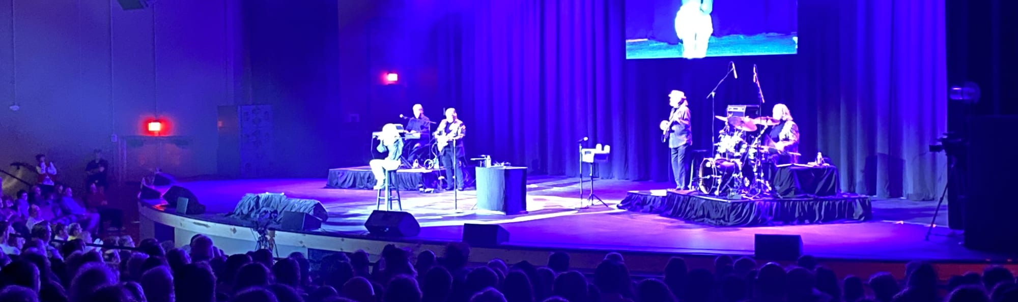 signer on stage in chair washed out by the lights DC